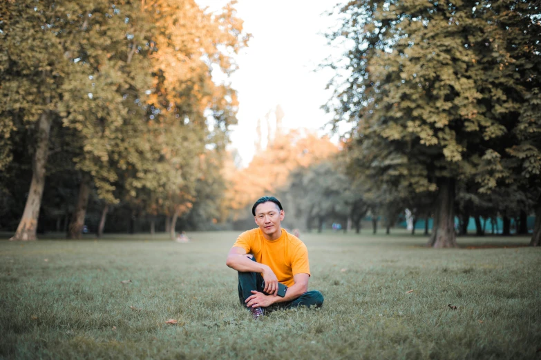 the woman is posing on the grass posing for a po