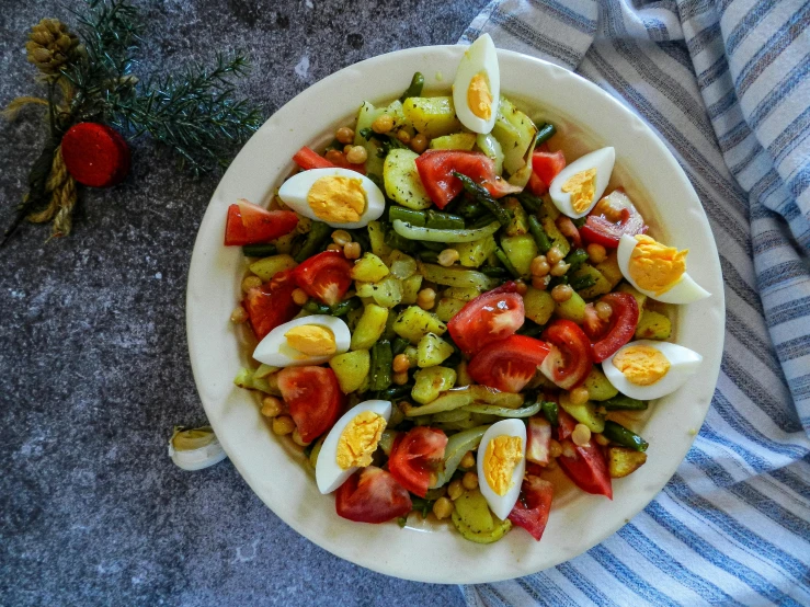 a bowl of food with eggs, tomatoes, beans and onions