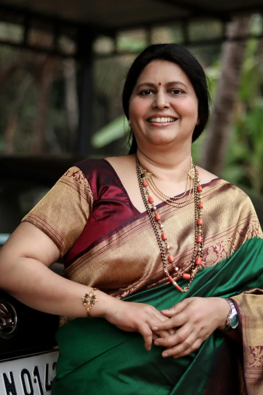 woman smiling at the camera with her saree and necklace
