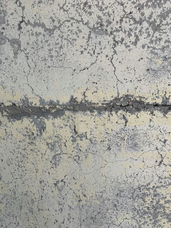 the texture of a cement wall with spots of black color