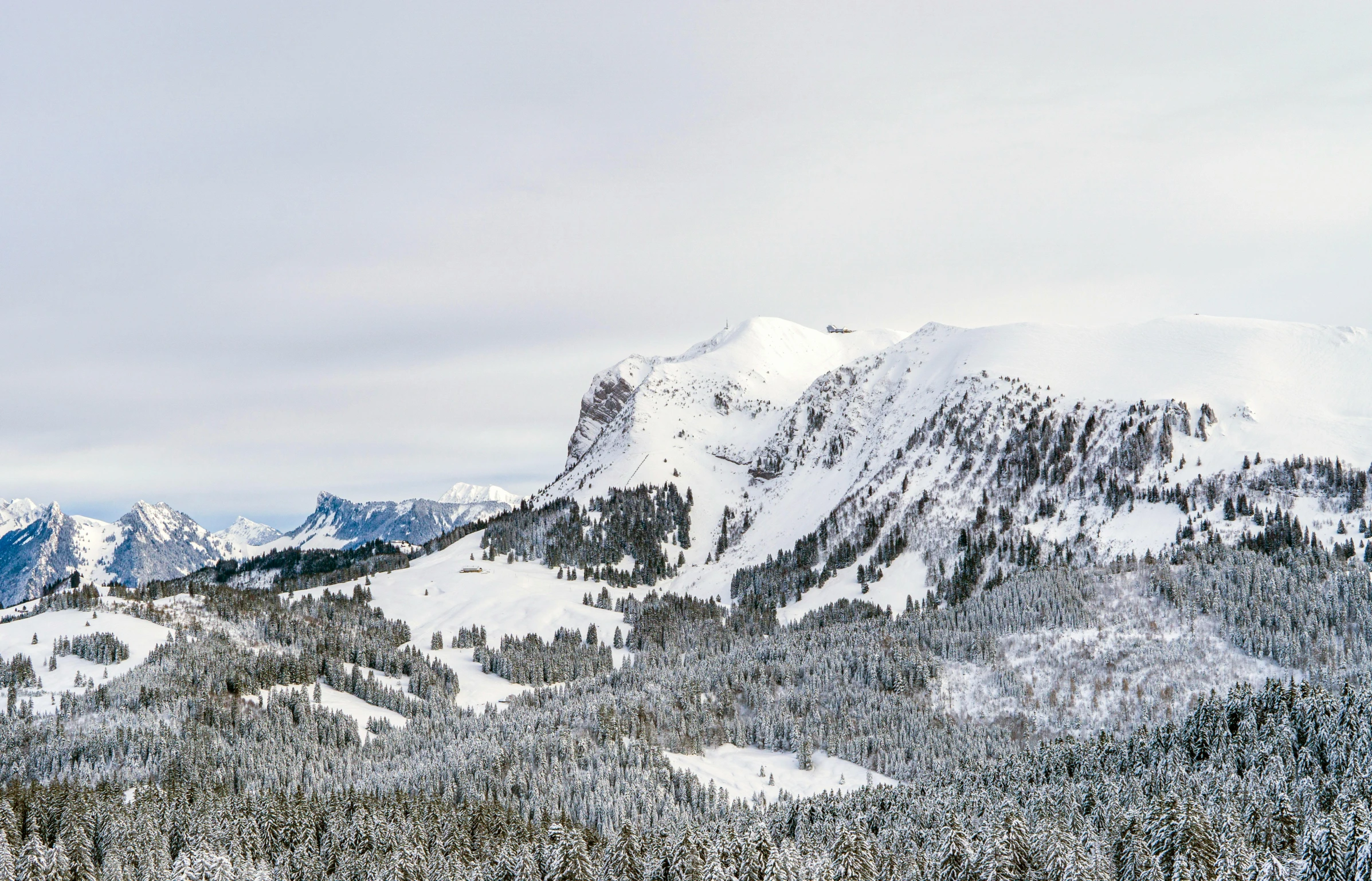 a mountain covered in lots of snow with a large sky above