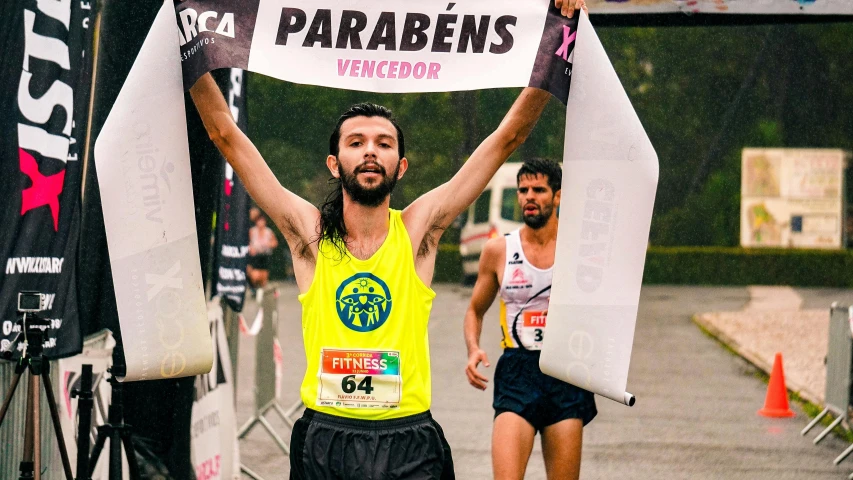 the runner is holding up his sign over his head