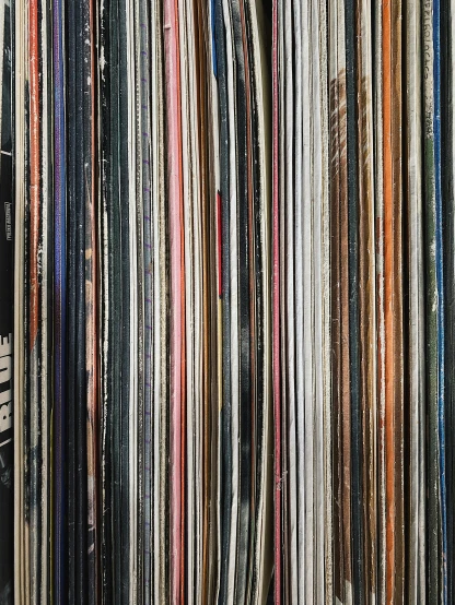 a row of different colored records on display