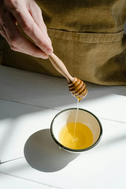 honey dip being poured into a small bowl