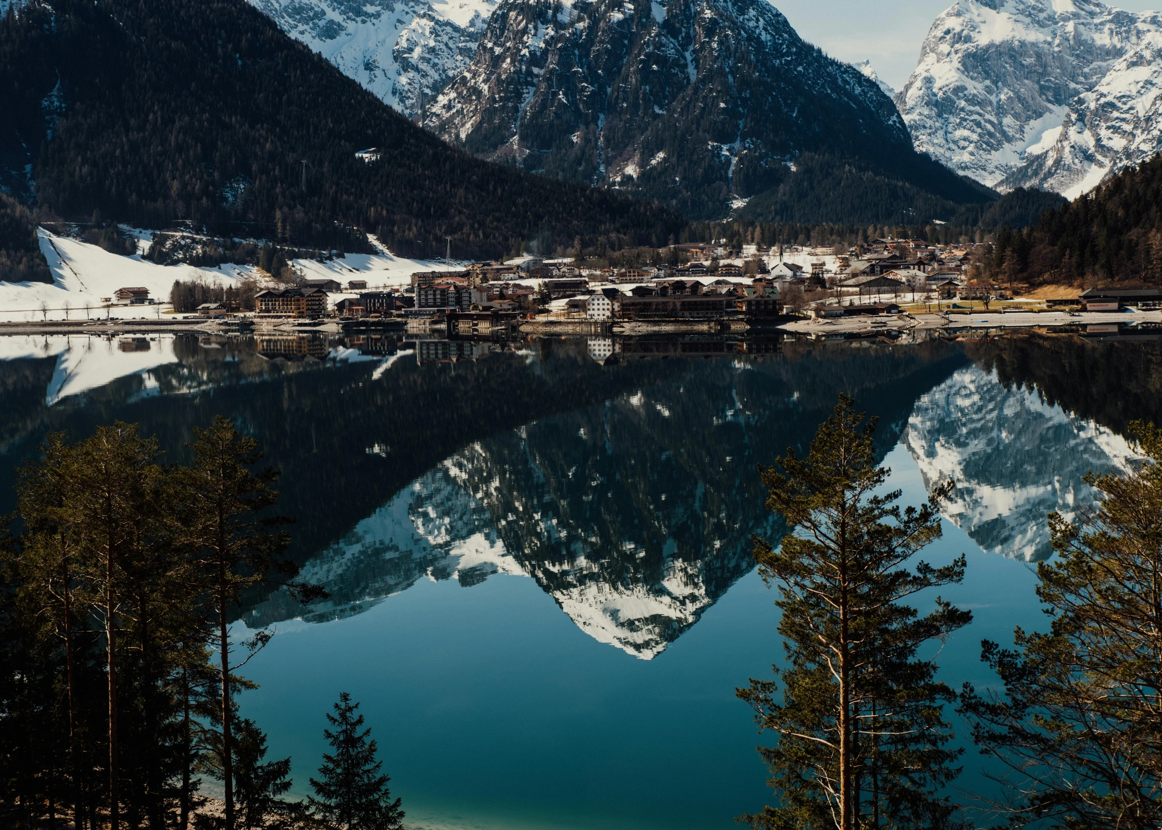 a snowy mountains range over a mountain village