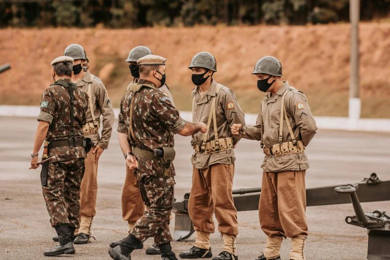 several uniformed people standing around talking