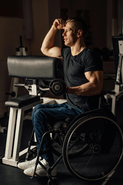 a man in a wheelchair working on a barbell