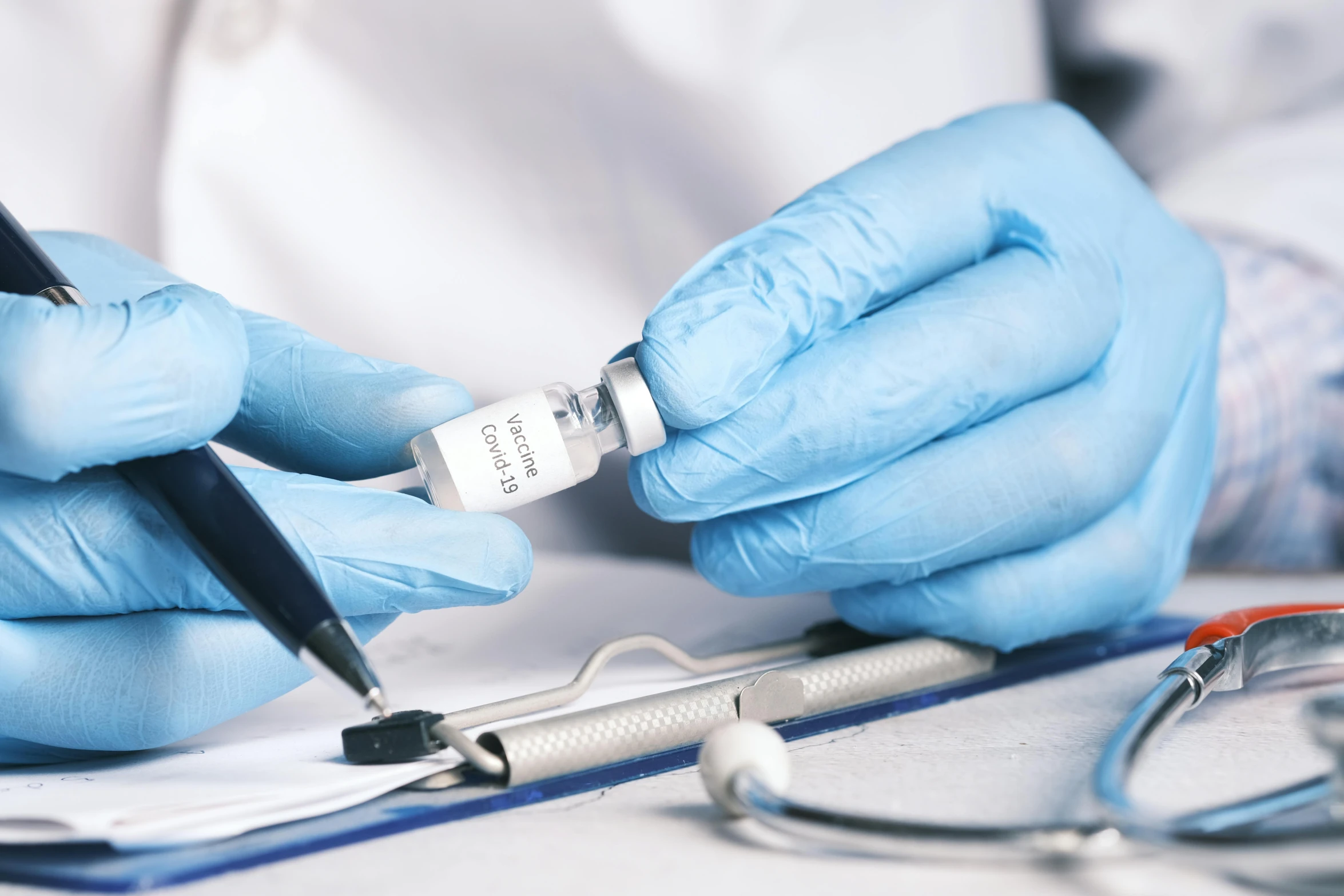 a doctor writes a test for an electronic device