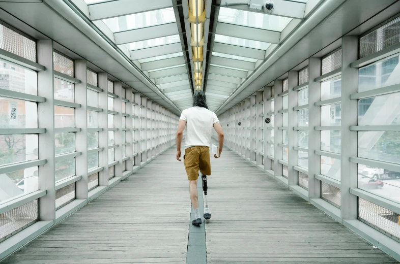 a man walking on a platform while using his crutches