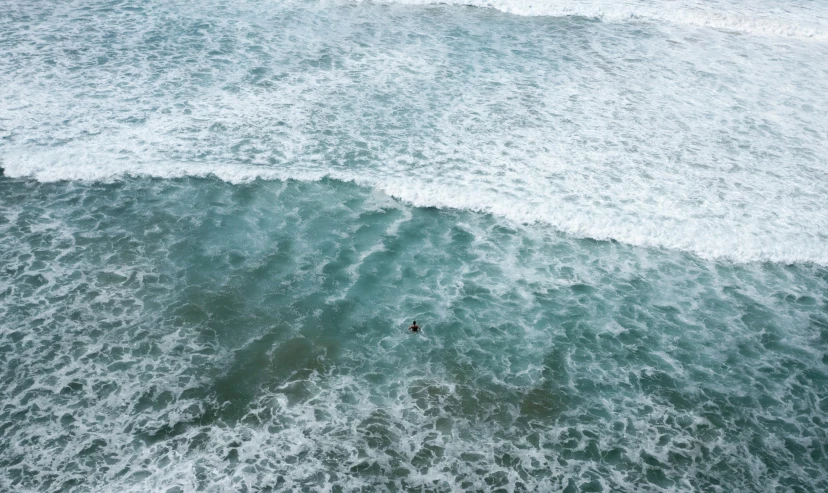 two people in the ocean surrounded by waves