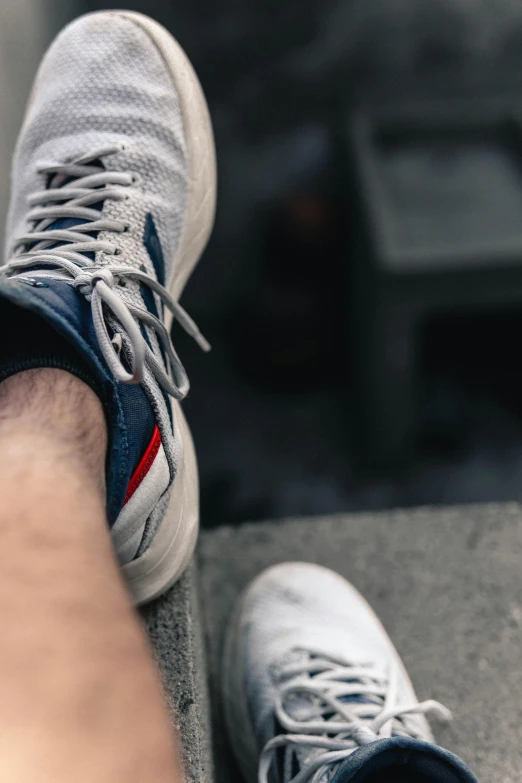 someone standing on the ground with sneakers on