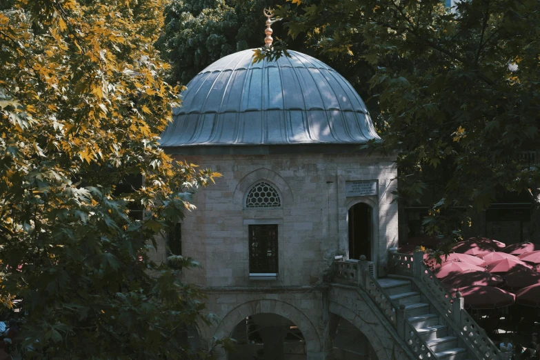 a building with a dome on top that has steps in front