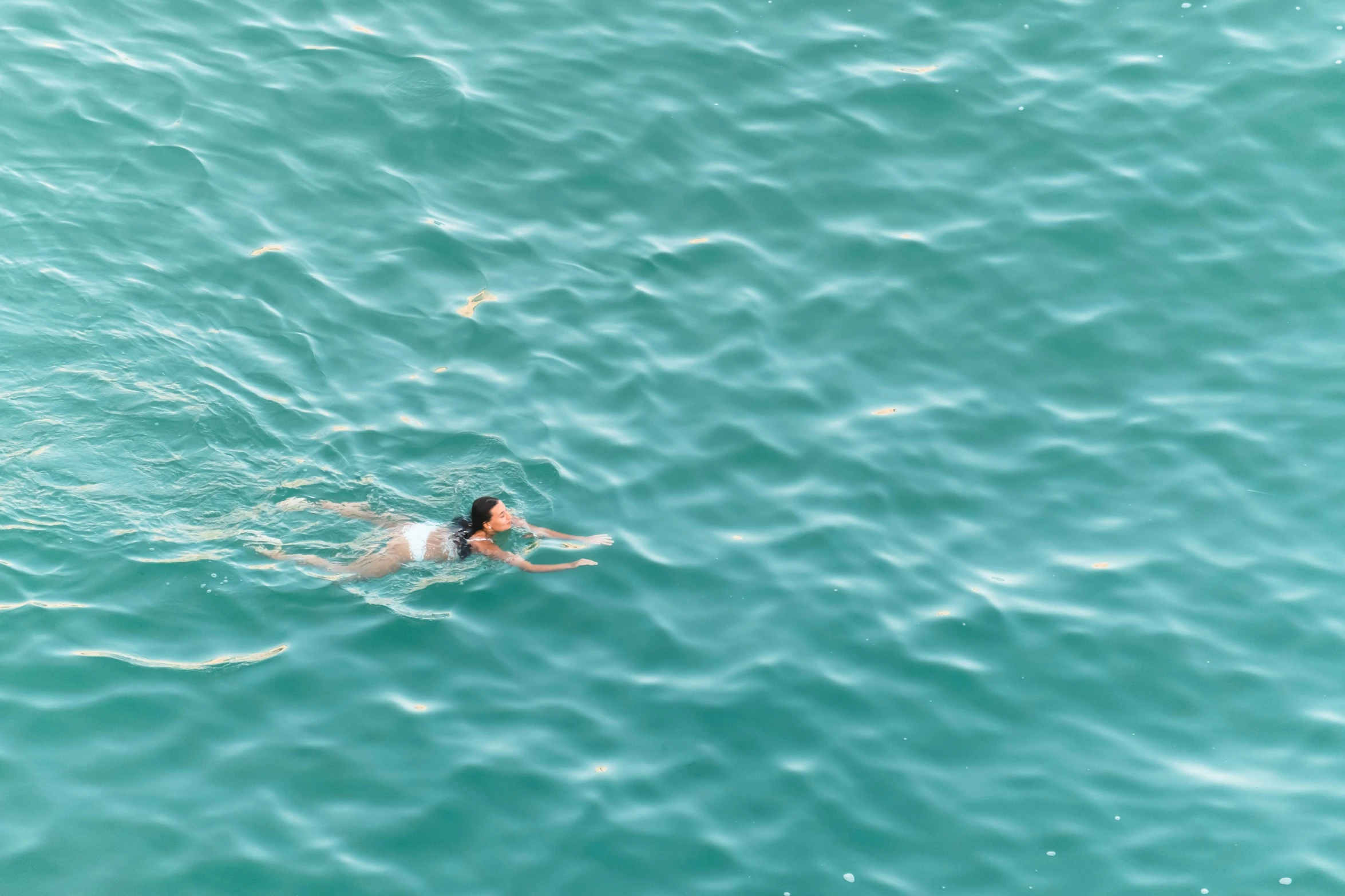 a person swimming on a body of water