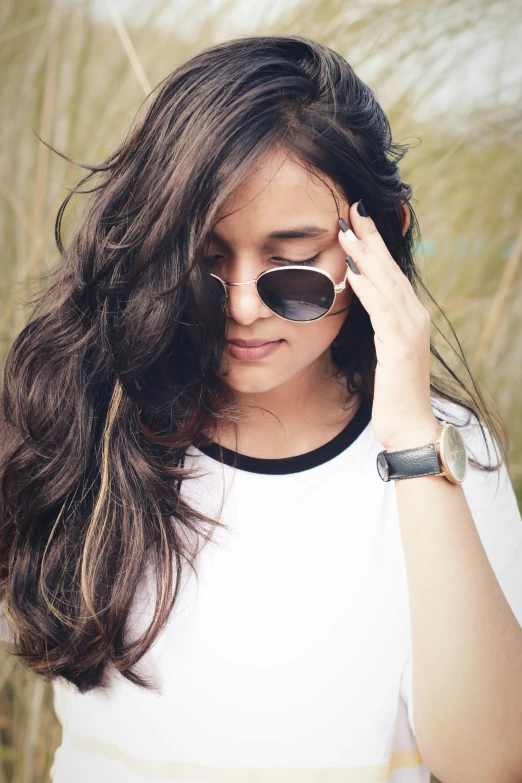 a woman wearing sunglasses with her hair down