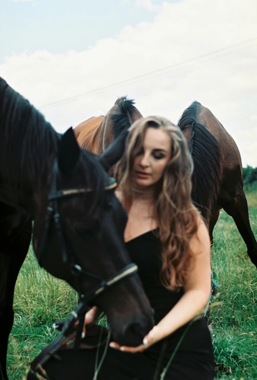 there is a beautiful young woman posing for a po next to her horse