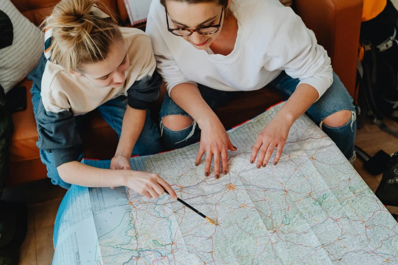 two young women looking at a map together