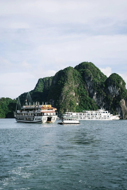 some large boats traveling in the middle of a river