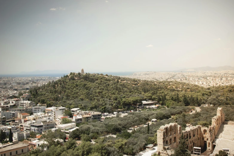 a large hill with a city in the background