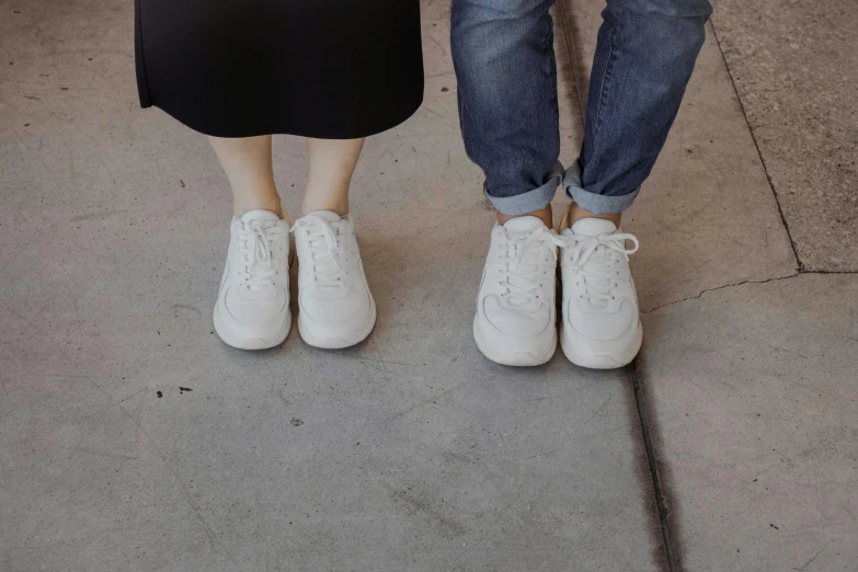 a couple with sneakers standing next to each other