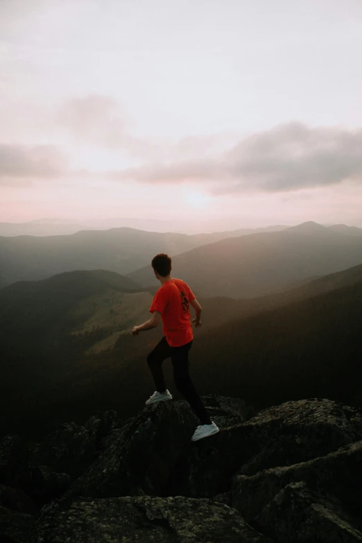 a man that is standing on a rock