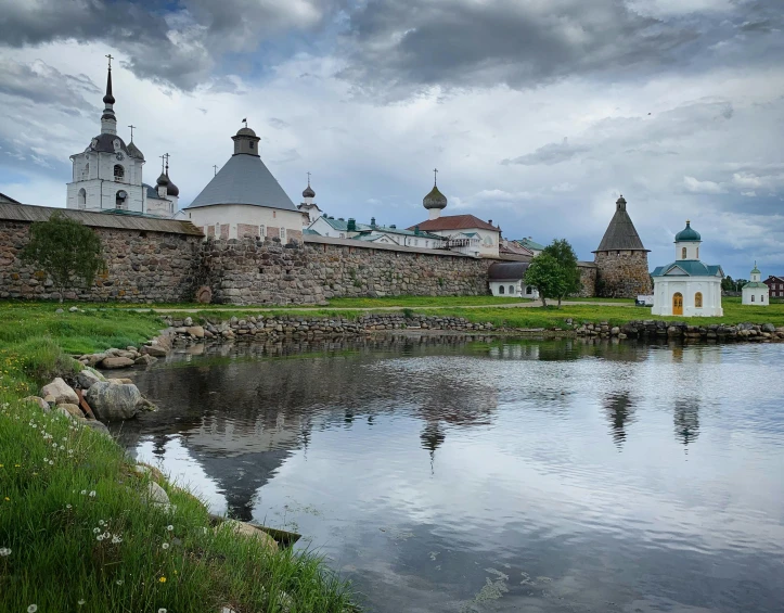 an old european town with a pond and castle like structures