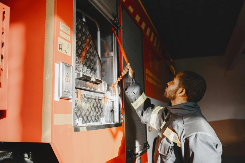 a man working on a machine that is parked