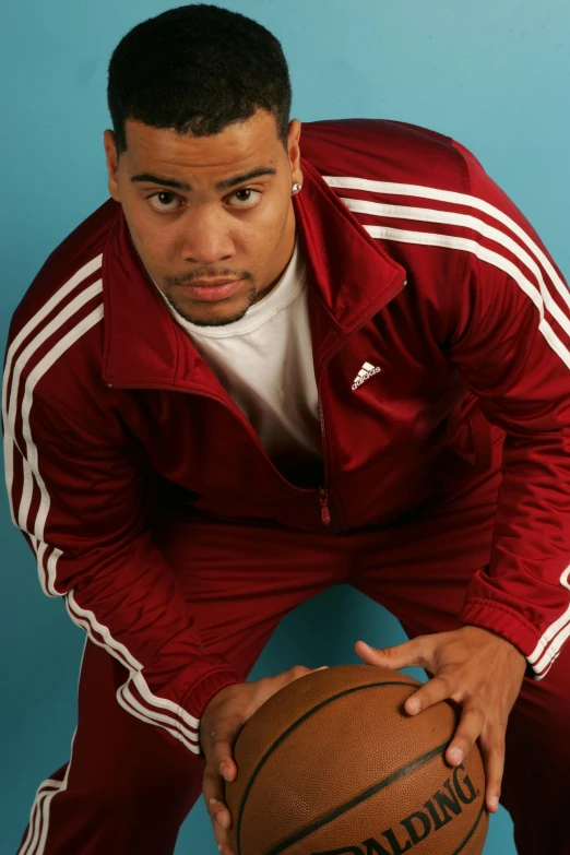 a male basketball player posing for a po
