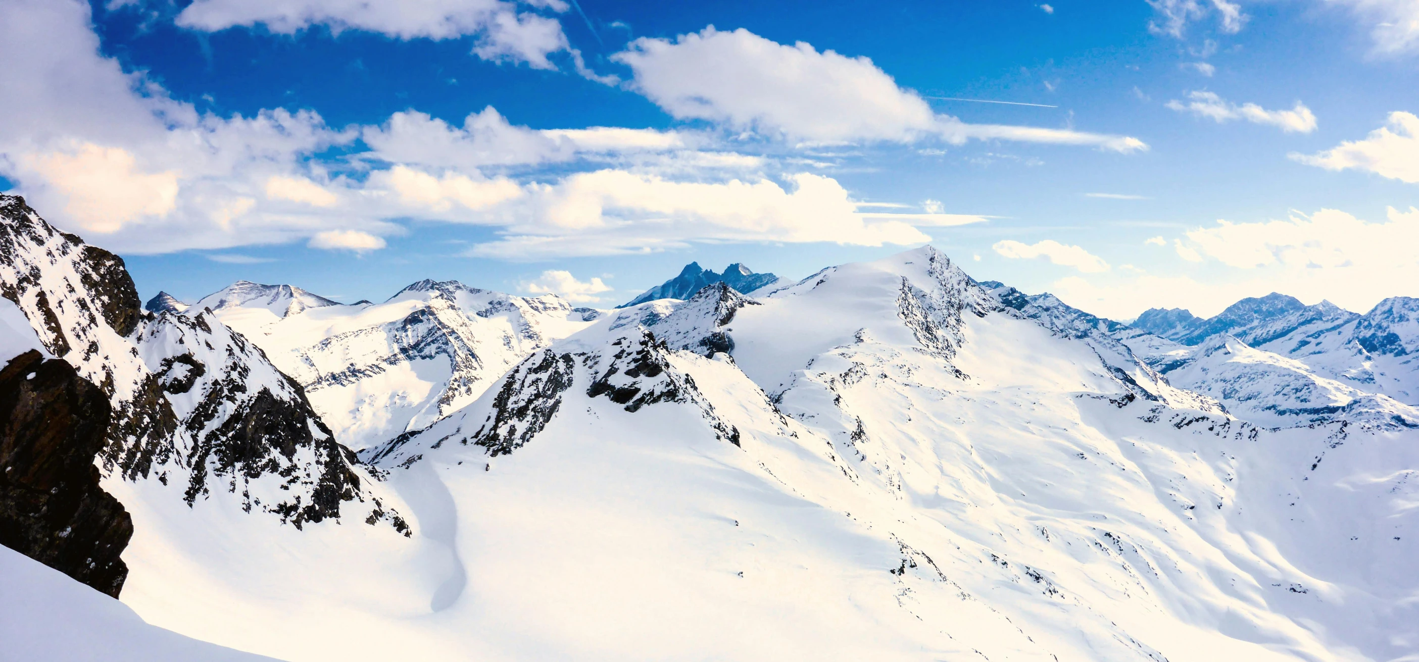 a man on skis is in the snow in front of mountains