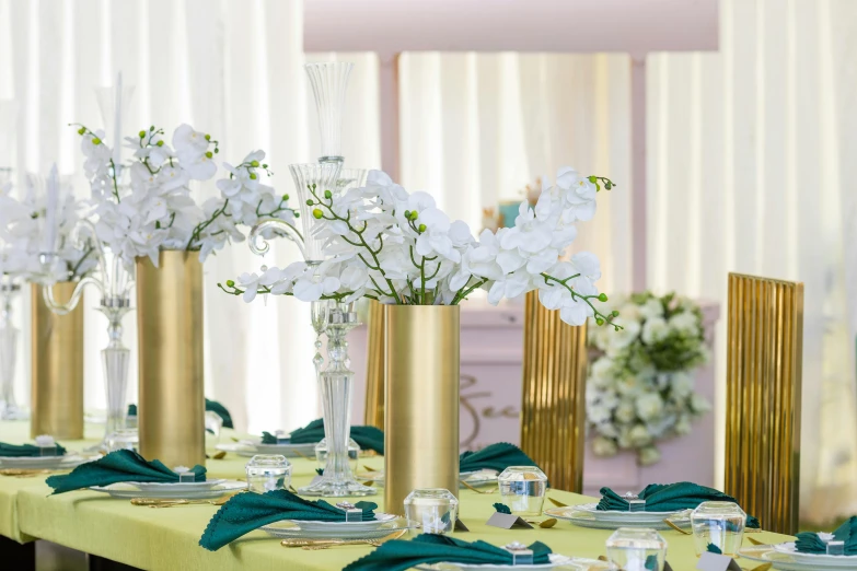 tall vases with flowers are sitting on a table