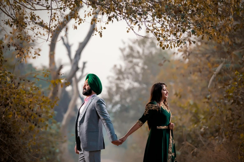 an indian couple holding hands and walking down a road