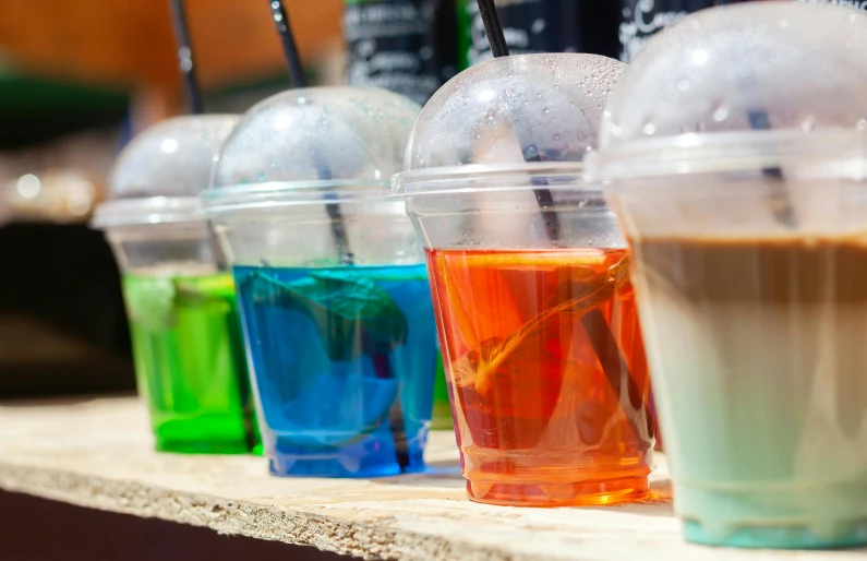 a row of cups of different colors of liquid