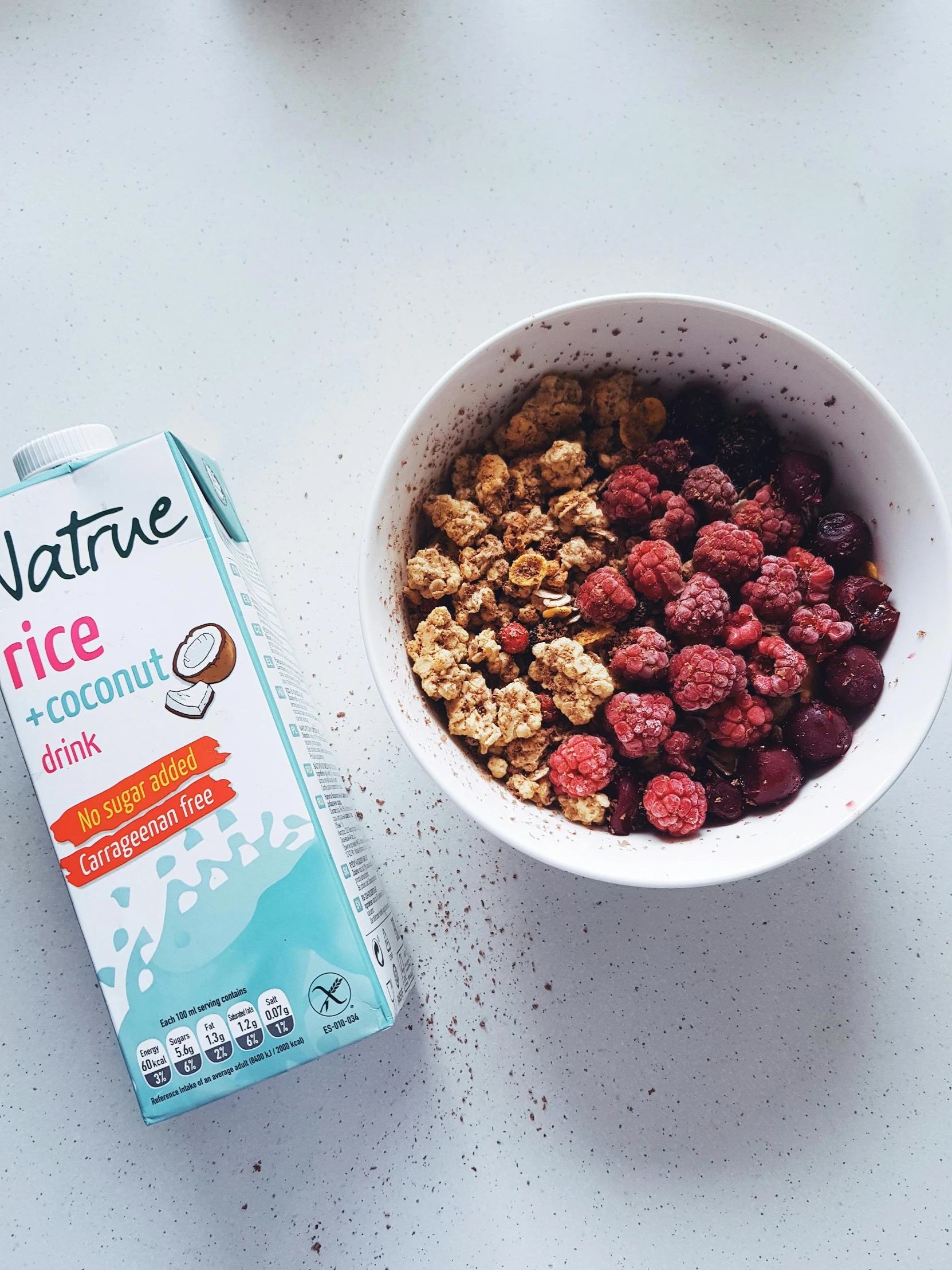 cereal in a bowl next to a carton of nutella