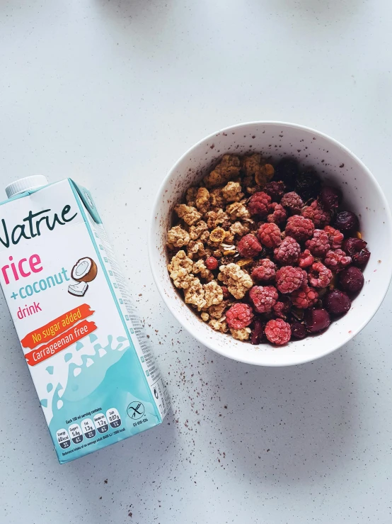 cereal in a bowl next to a carton of nutella