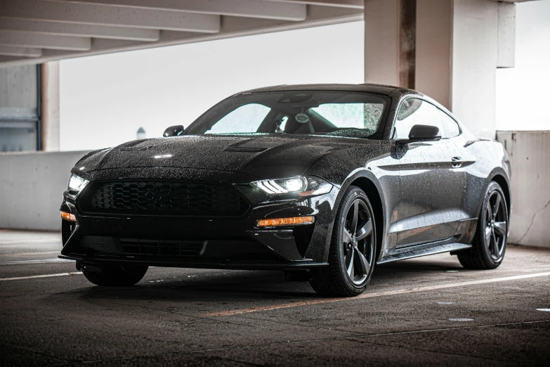 the front end of a gray car is covered in black powder