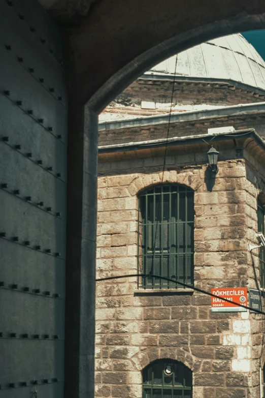 a large building with iron bars near an alley way