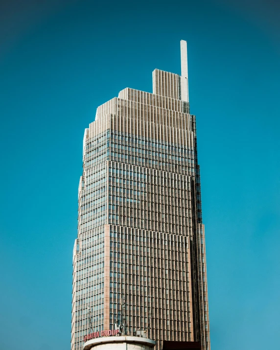 this building is large and very tall against a blue sky