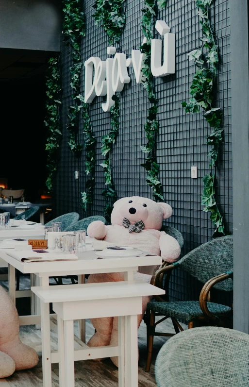 a stuffed bear sitting in front of some chairs