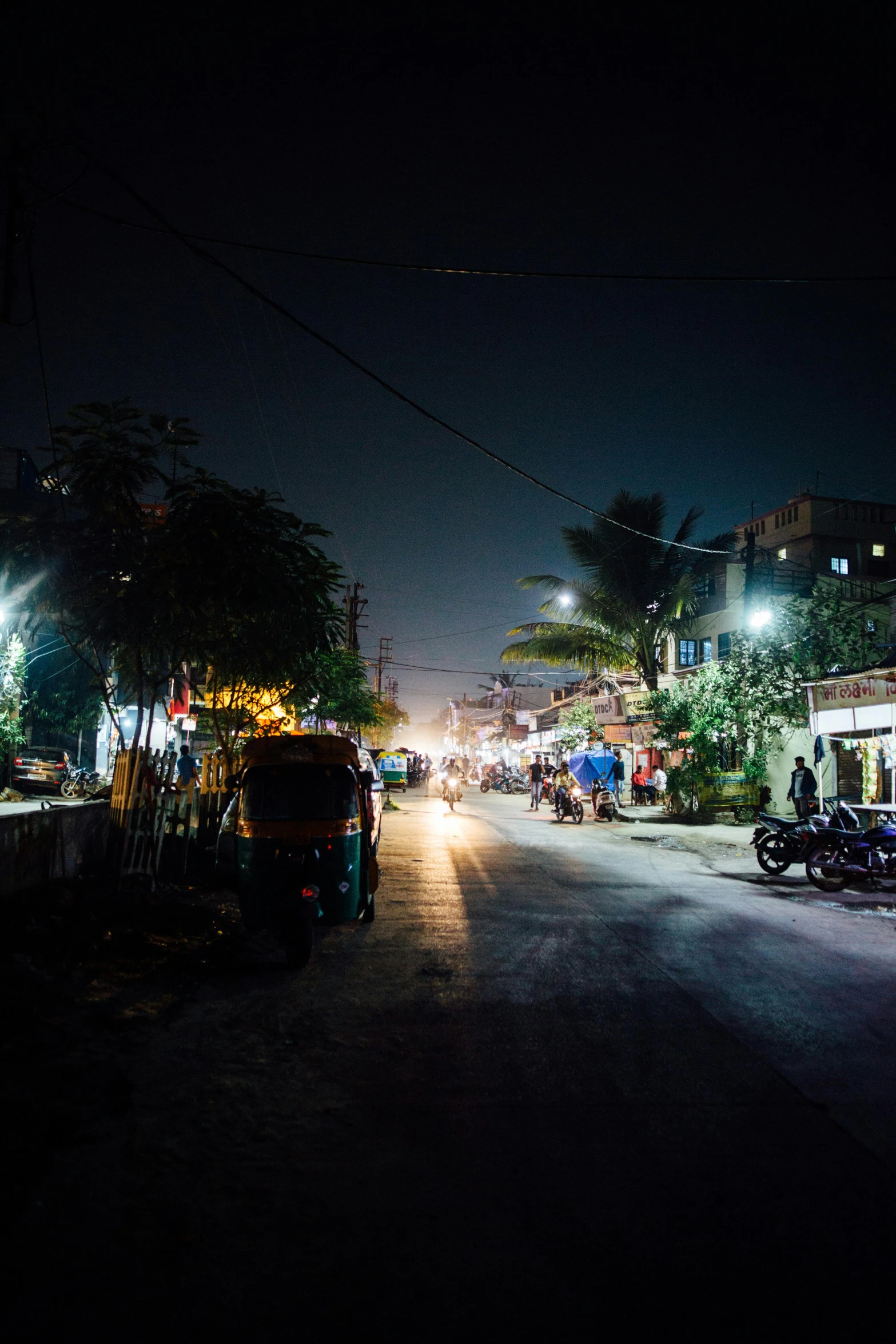 a city street at night with a lot of lights in the background