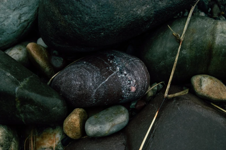 the black stones and brown rocks are next to each other