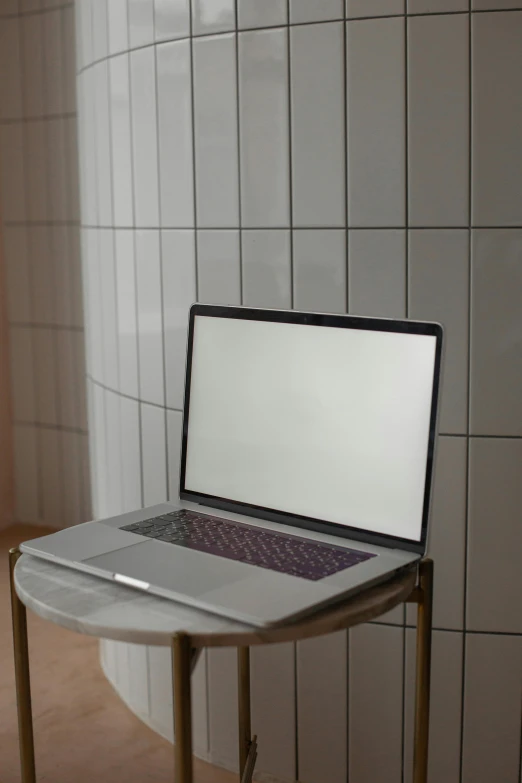 a laptop sitting on top of a metal desk