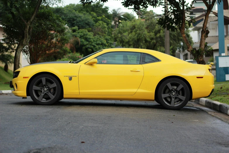 a yellow car driving down the street