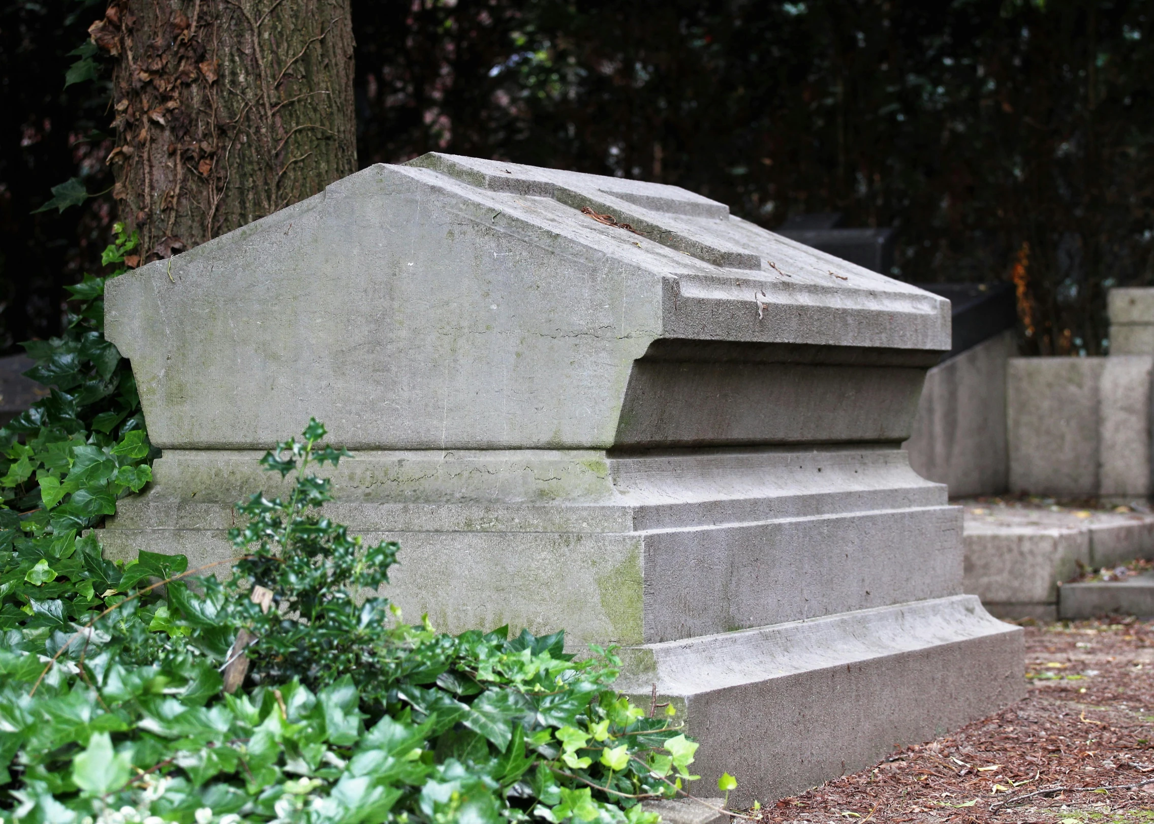 a small stone monument next to some trees