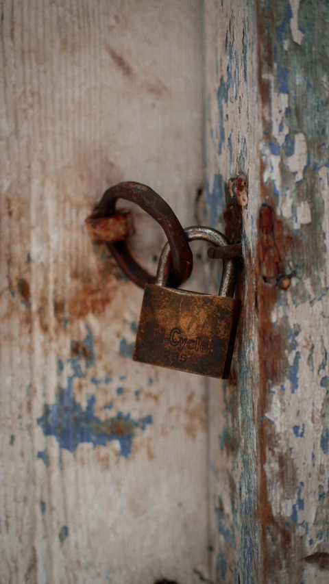 an old padlock with chain and shack attached to it