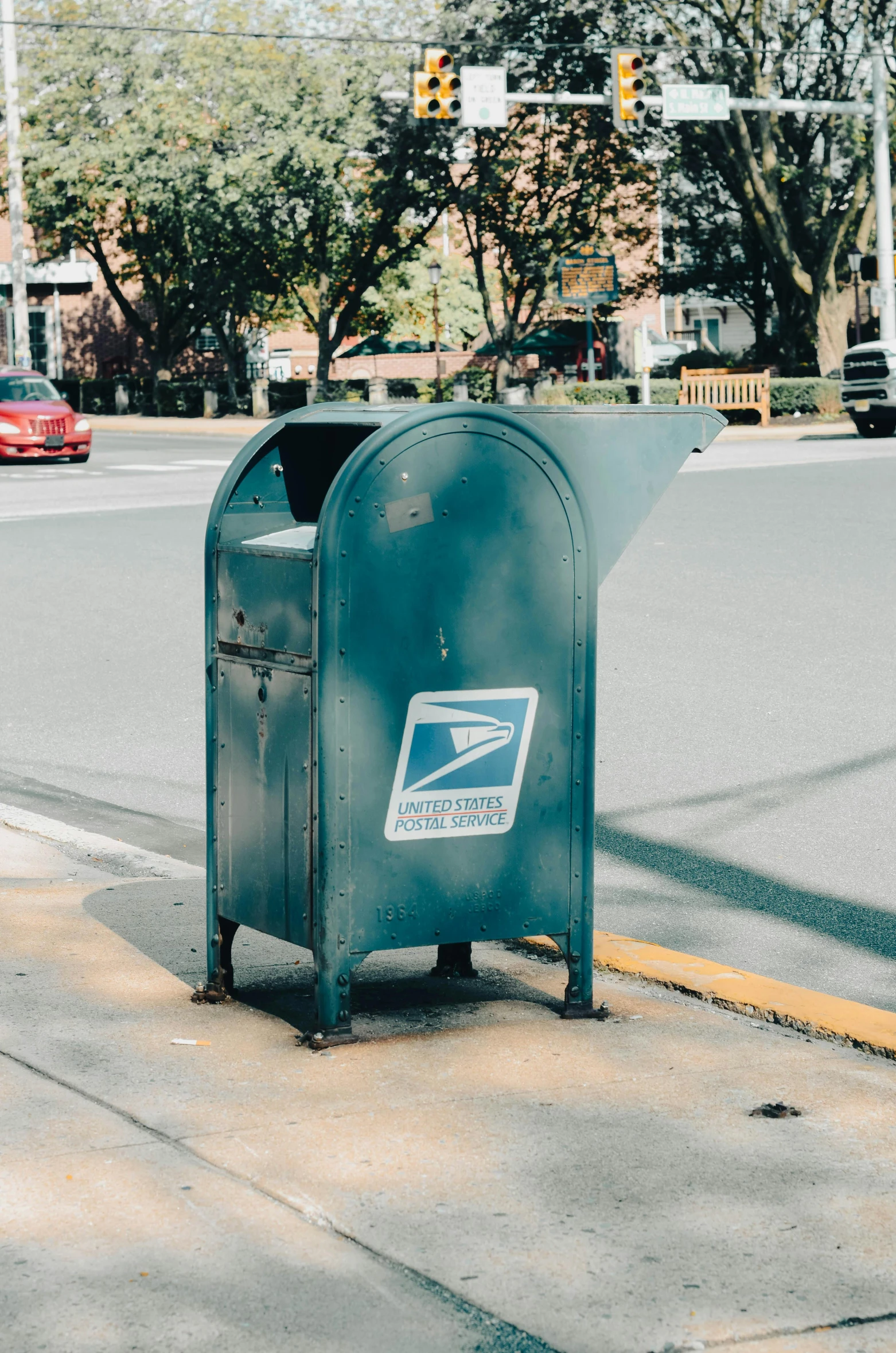 mailbox on the sidewalk at the corner of a city street