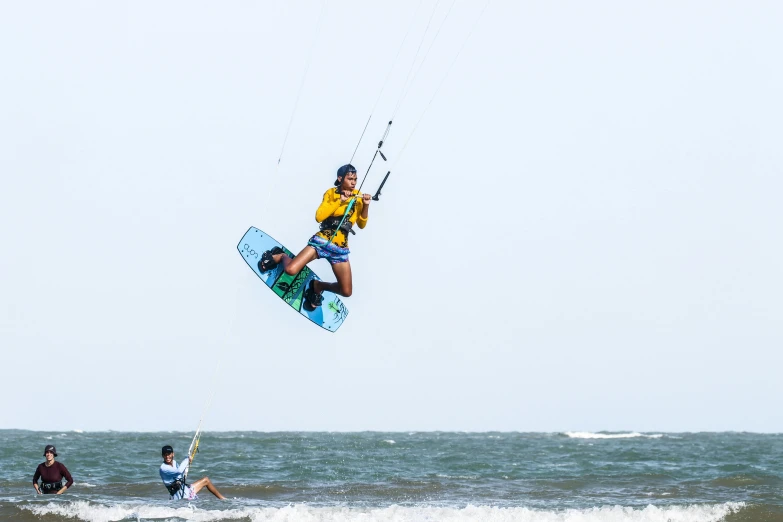 a man on a surfboard does a trick in the air