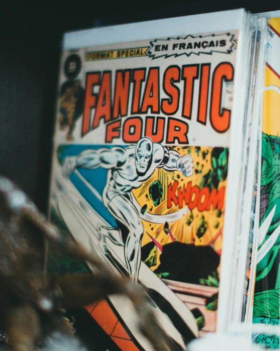 a person reading a book with comics on the cover