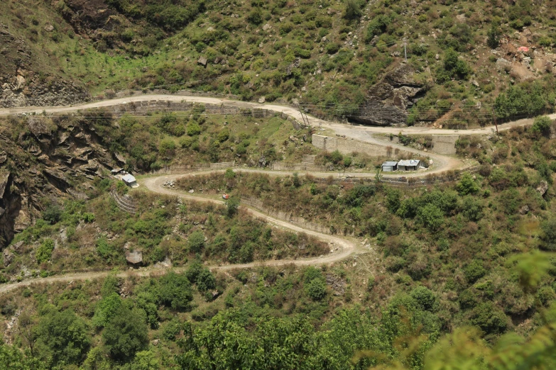 a scenic mountain side road has curve roads in it