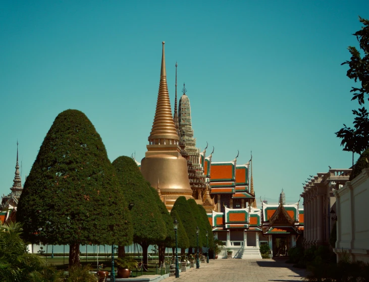 a golden spire is in the distance of a large city