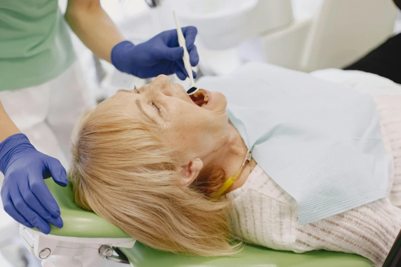 a woman who is sitting on the dentist chair