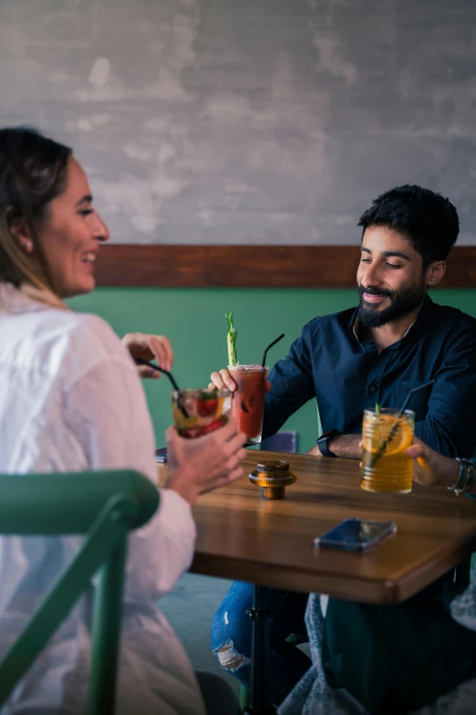 a man and woman enjoying a drink in a restaurant